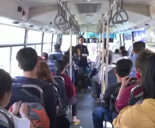 a salesman promotes peerer in a city bus.